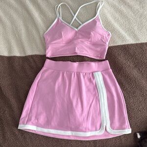 Pink Two-Piece Sports Bralette and Skort Set with White Trim